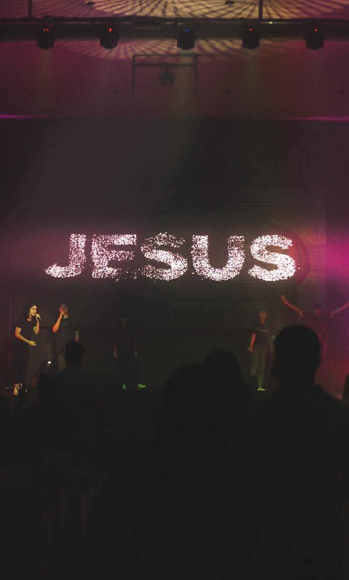 A dynamic worship music concert with a focus on Jesus, featuring live performers and vibrant lighting.